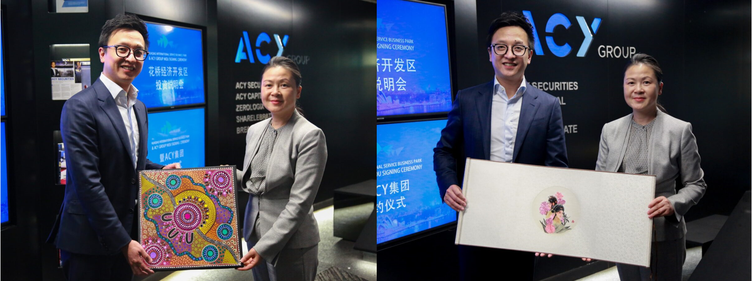 A person and person standing in front of a screenDescription automatically generated